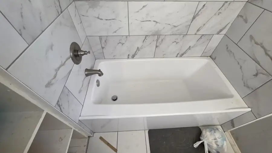 Bathroom tub and tile surround recorded in good condition