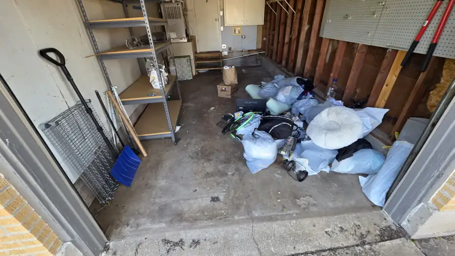 Garage with trash and items left behind, documented for trash-out