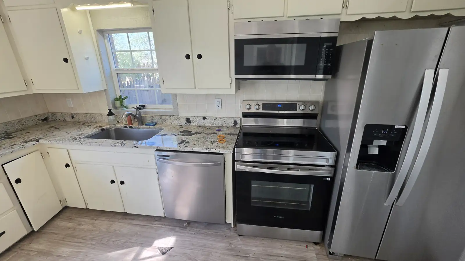 Kitchen with stainless appliances photographed during a Blaze onboarding inspection